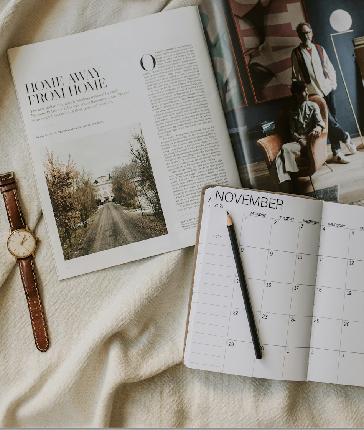 Planner, magazine, and watch on linen